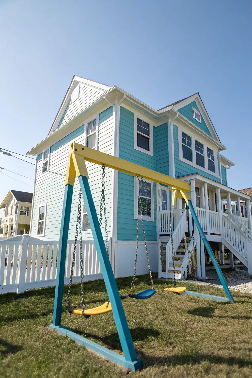 A backyard swing set painted to match the color scheme of the nearby house.