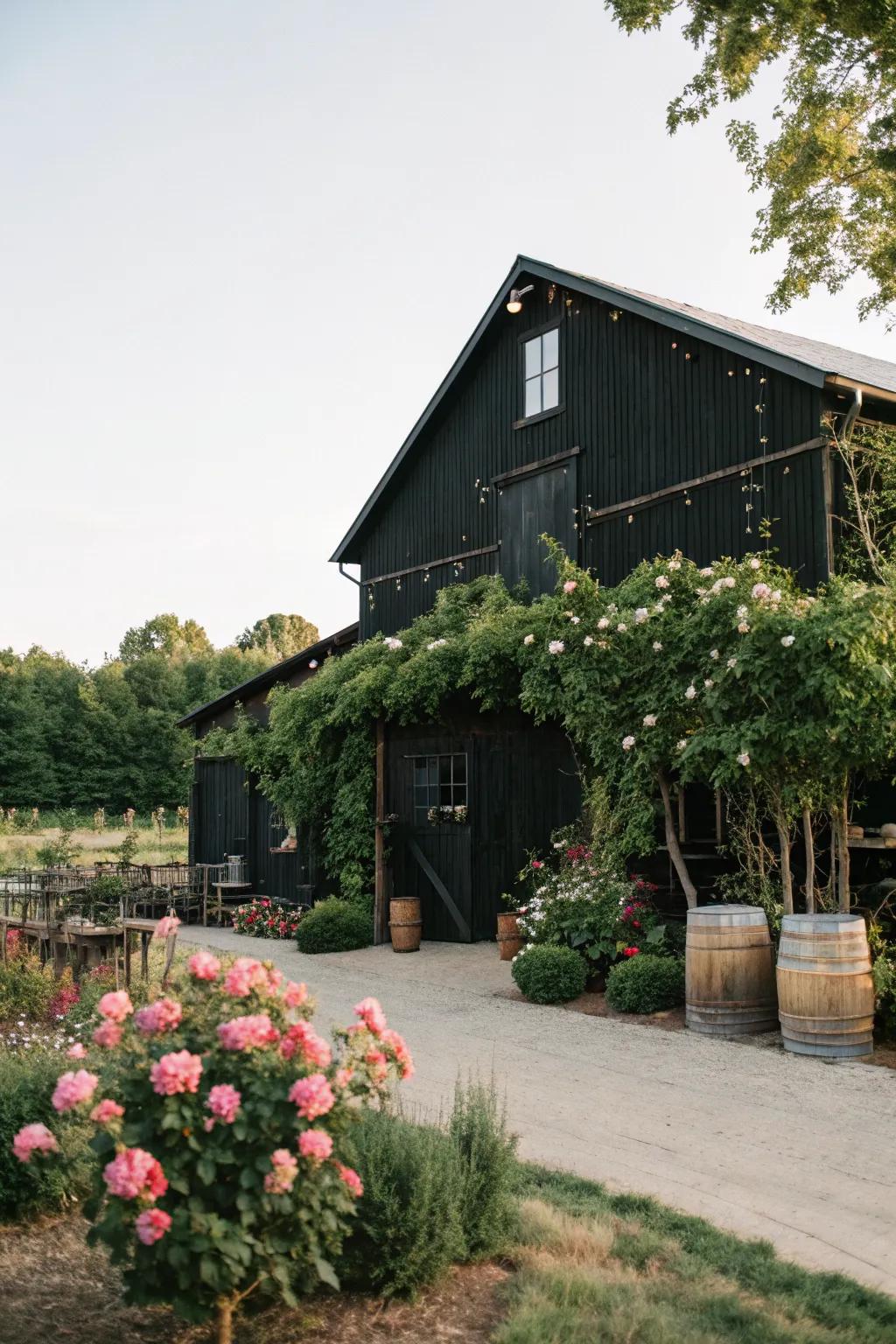 A black barn enhanced with decorative plants and outdoor elements.