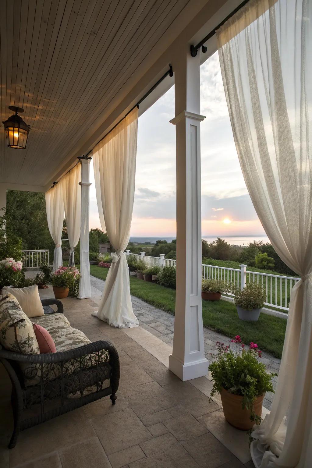 A porch with soft, flowing curtains creating a private and elegant space.