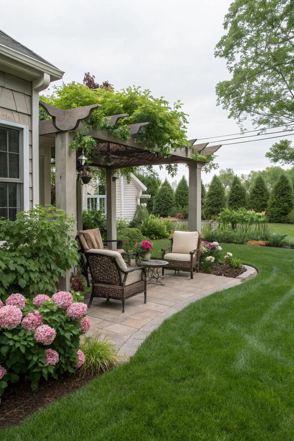 A front yard with a cozy seating area shaded by a pergola.