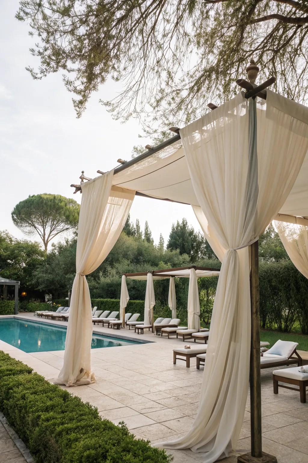 Fabric canopies create a gentle, flowing shade over pool spaces.