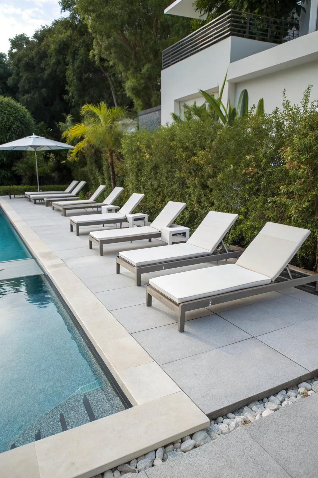 A modern poolside area featuring slip-resistant resin surfacing.