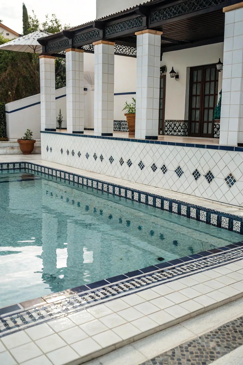 Dramatic contrast of white tiles with dark accents in a pool setting.